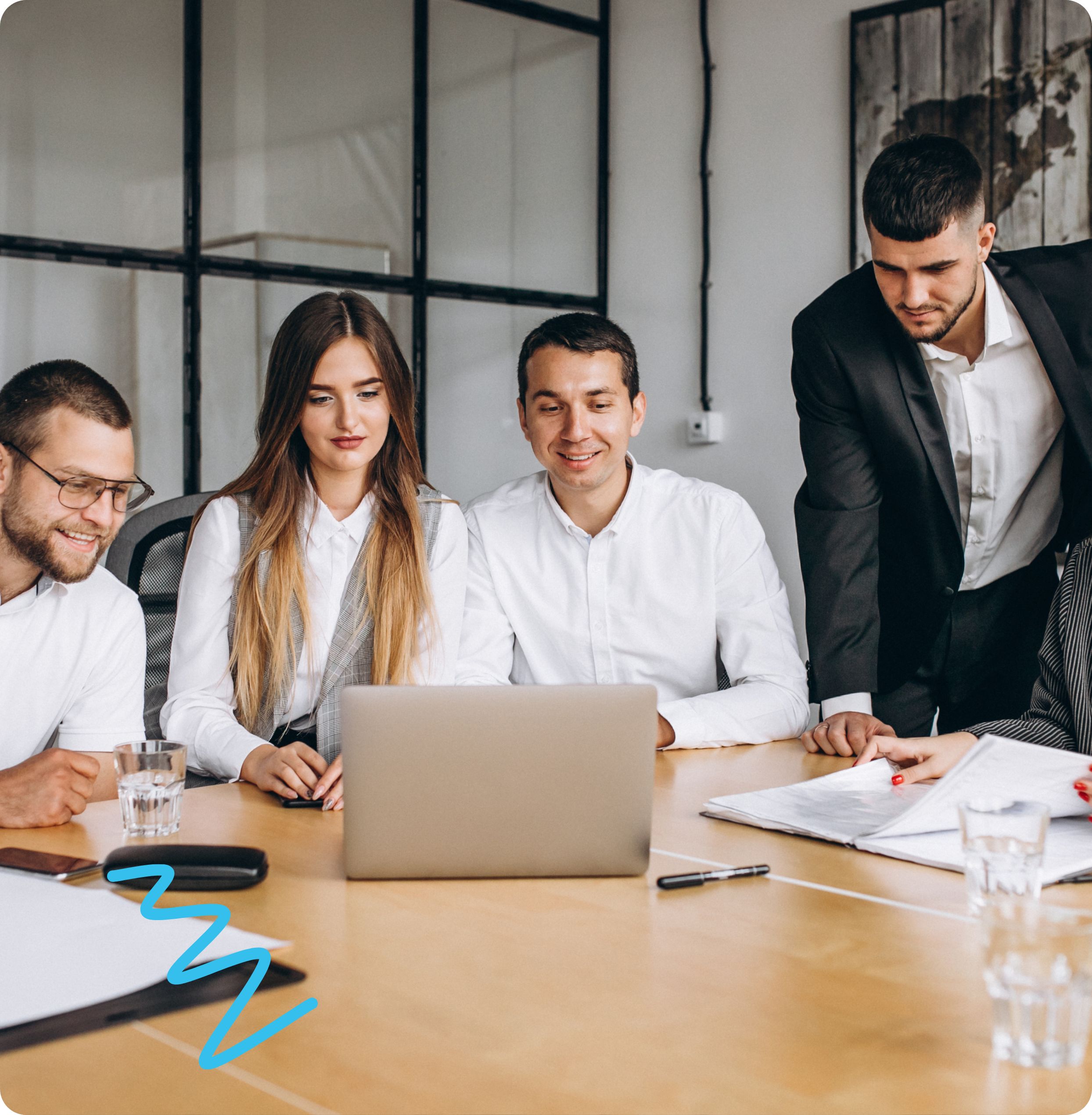 SigiloTech team members collaborating around a table during a project meeting