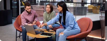Team members discussing ideas at a shared workspace